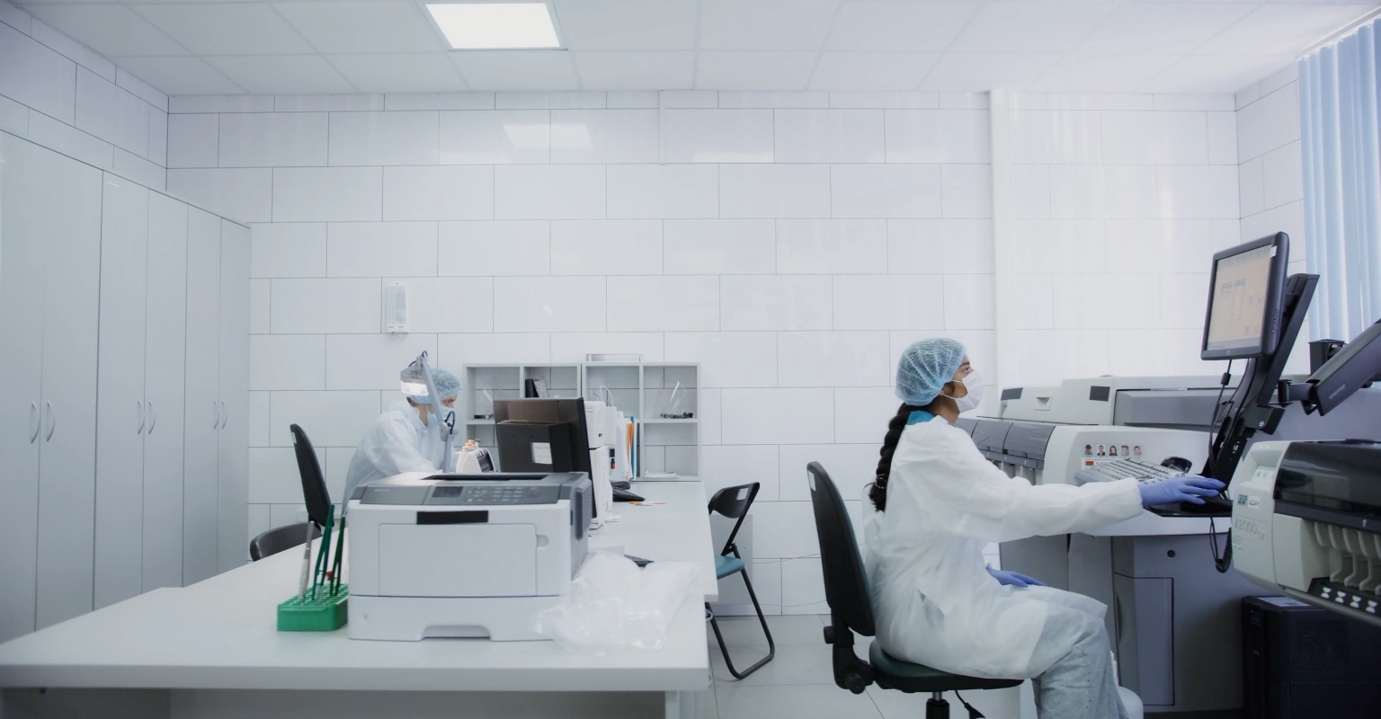 Clinician reviewing results on a laptop next to a saliva drug test kit